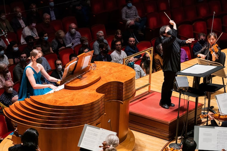 Organist Monica Czausz Berney with conductor conductor Xian Zhang in the world premiere of "When It Hits the Ocean Below" by Melody Eotvos, performed by the Philadelphia Orchestra on Thursday in Verizon Hall.