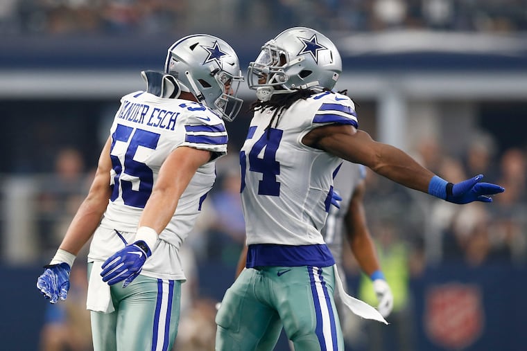 Dallas Cowboys linebackers Leighton Vander Esch (55) and Jaylon Smith (54) celebrate a tackle against the Detroit Lions on September 30, 2018, at AT&T Stadium in Arlington, Texas. (Jim Cowsert/Fort Worth Star-Telegram/TNS)