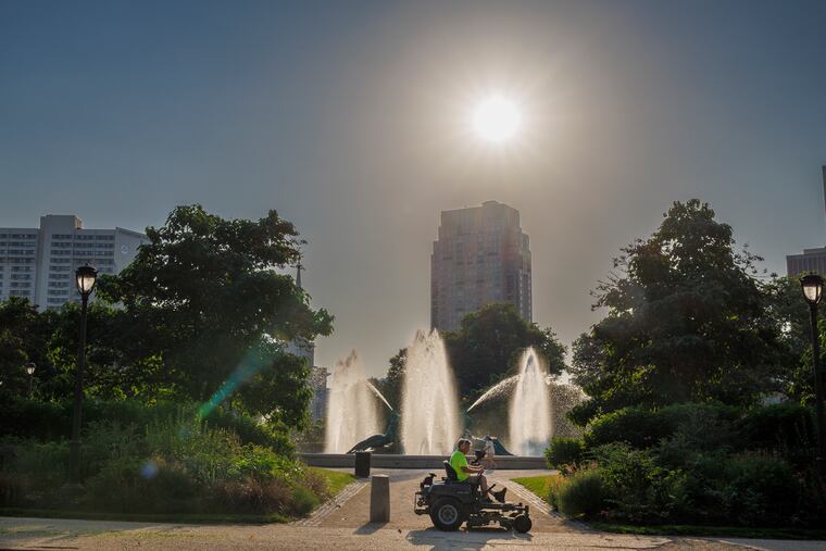 A landscaper on the warm morning in Philadelphia in June. Sunday should be another decent day, but an air quality alert for ozone is in effect for the Philly area.