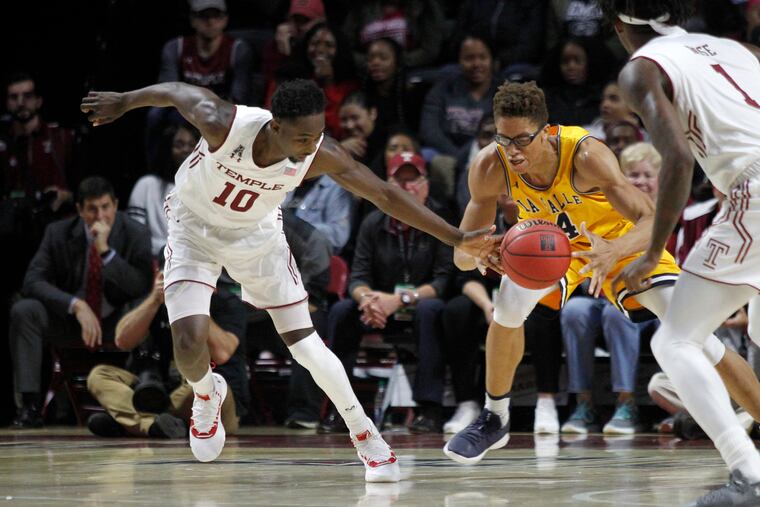 Temple's Shizz Alston Jr (left) and La Salle's Miles Brookins fight for ball control in the first half the teams' season opener.