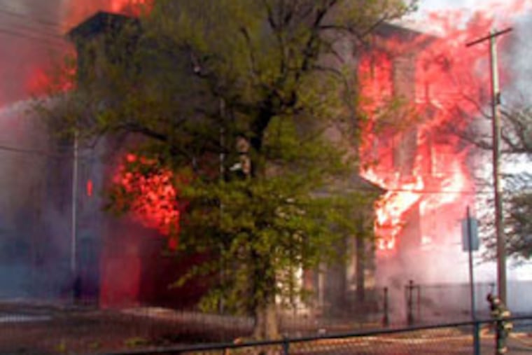 Firefighters work on a fire that erupted the the Prince of Peace Baptist Church Tuesday morning. (David Swanson / Inquirer)