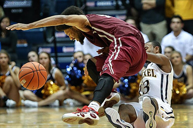 Drexel's Rashann London collides with Saint Joseph's DeAndre' Bembry during the second half. (Steven M. Falk/Staff Photographer)