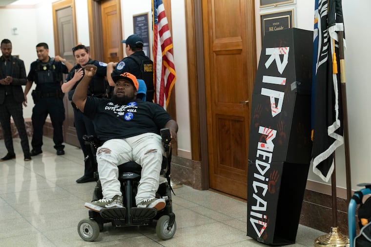 A demonstrator protests proposed Medicaid cuts outside the office of Sen. Bill Cassidy (R., La.) on Capitol Hill on June 11.