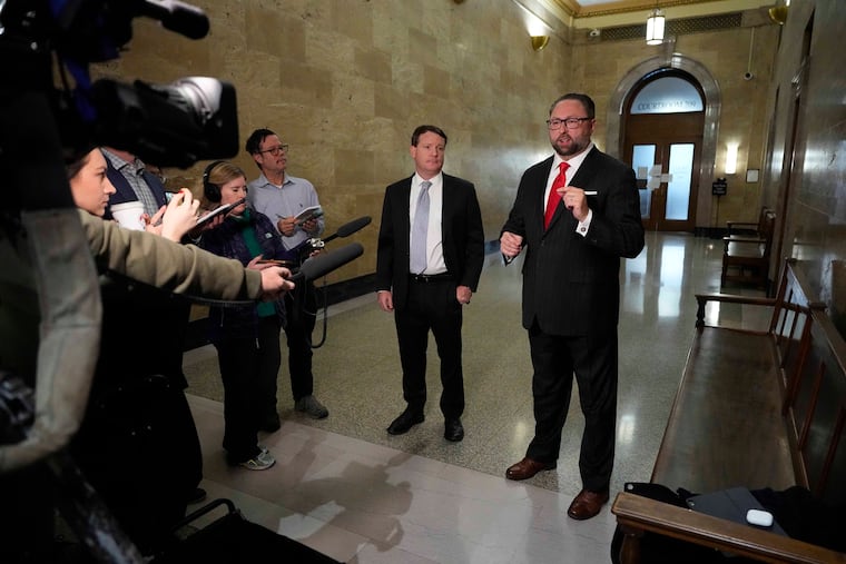 Mike Davis (center left), the founder and president of the Article III Project, and Donald Trump's campaign adviser Jason Miller talk outside a Denver courtroom before an Oct. 30 hearing for an unsuccessful lawsuit that sought to keep Trump off the Colorado ballot.