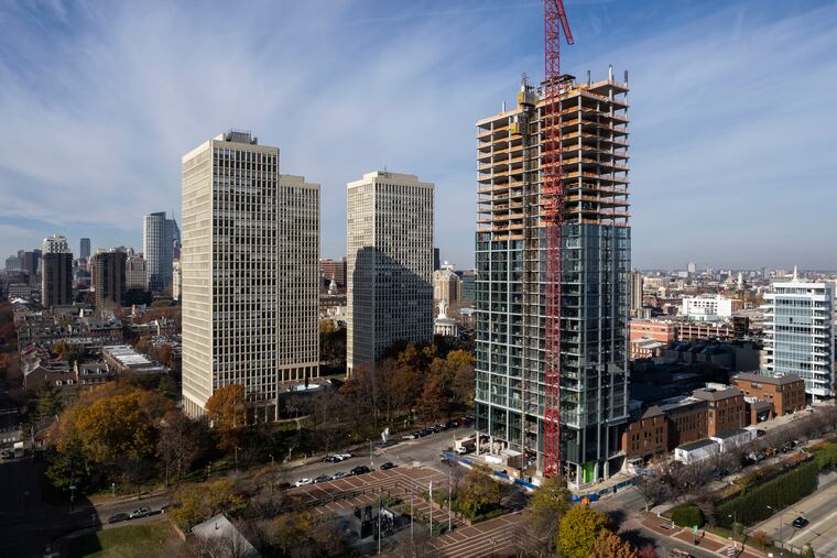 Construction continues at 1 Dock Street (right) in Philadelphia on Monday.
