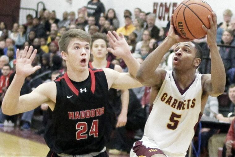 Haddon Heights’ Jared Latane hits this fadeaway jumper in the last second of the third quarter despite defense by Haddonfield’s Aiden Blake.