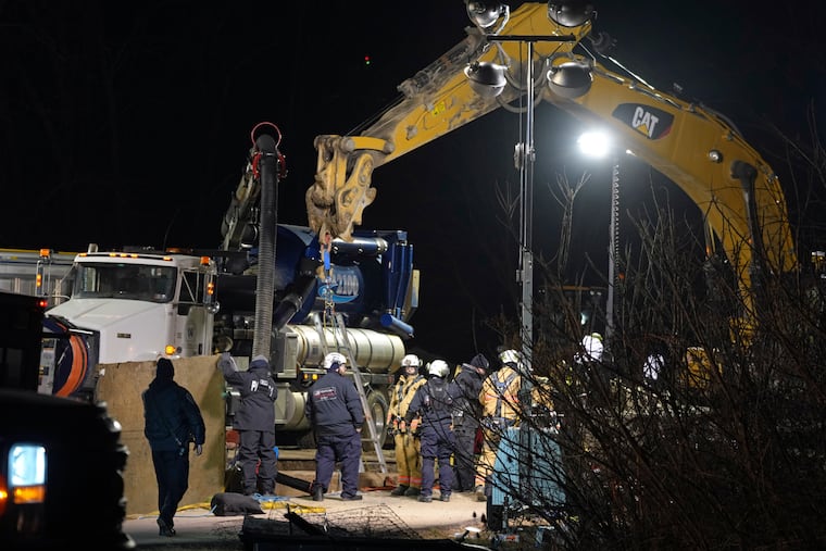 Rescue workers search through the night in a sinkhole for Elizabeth Pollard, who disappeared while looking for her cat, in Marguerite, Pa.
