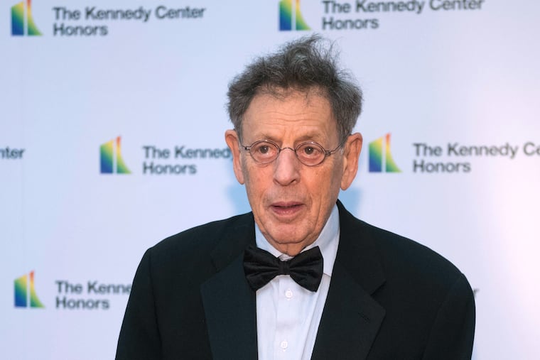 FILE - 2018 Kennedy Center Honoree composer Philip Glass arrives at the State Department for the Kennedy Center Honors State Department Dinner, Dec. 1, 2018, in Washington. (AP Photo/Kevin Wolf, File)