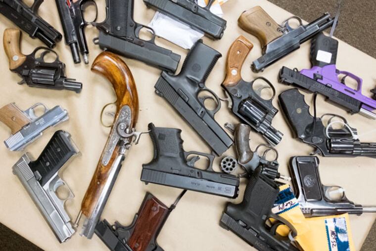 Assorted weapons that will be taken to a trash-to-steam plant for conversion. (ED HILLE/Staff Photographer)