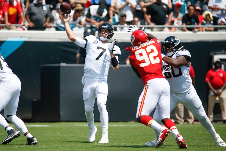 Jacksonville Jaguars quarterback Nick Foles (7) throws a pass as he is pressured by Kansas City Chiefs defensive end Tanoh Kpassagnon (92) during the first half of an NFL football game, Sunday, Sept. 8, 2019, in Jacksonville, Fla. (AP Photo/Stephen B. Morton)