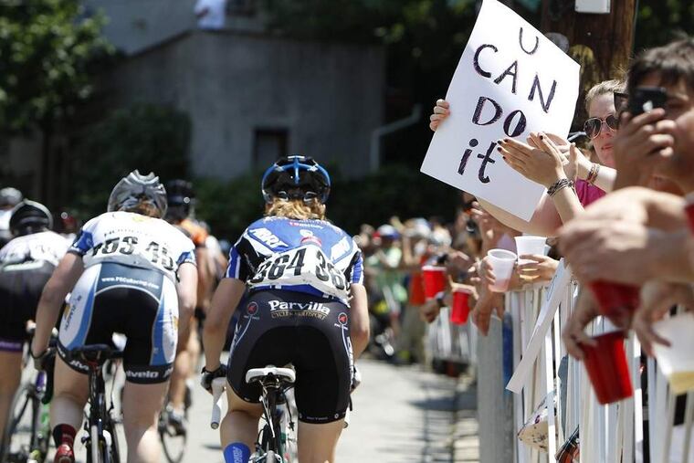 Fans cheer cyclists as they climb the Wall Manayunk last Sunday.
PHOTOS: DAVID MAIALETTI / STAFF PHOTOGRAPHER