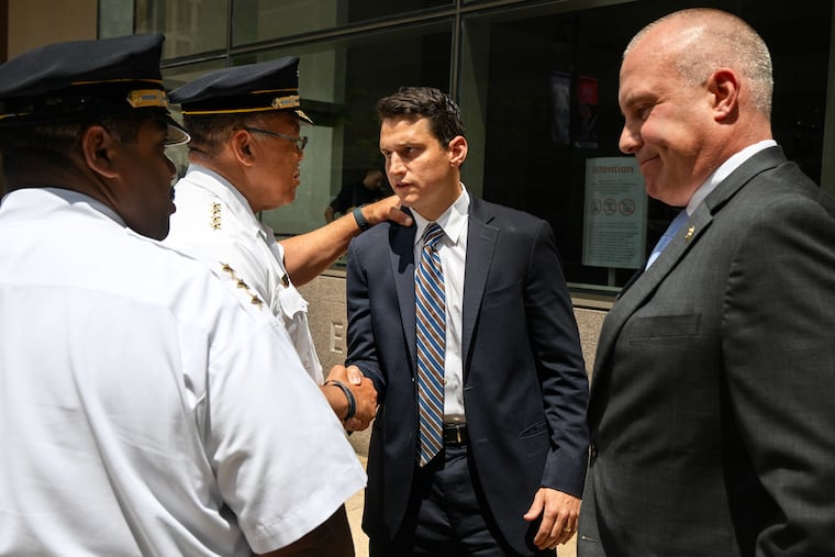 Police Commissioner Kevin Bethel (center, left) and U.S. Attorney David Metcalf (center, right) are outside Federal Court Wednesday, July 23, 2025 after Hassan Elliott, who fatally shot Philadelphia SWAT Cpl. James O’Connor IV in 2020, was sentenced to 75 years in federal prison.