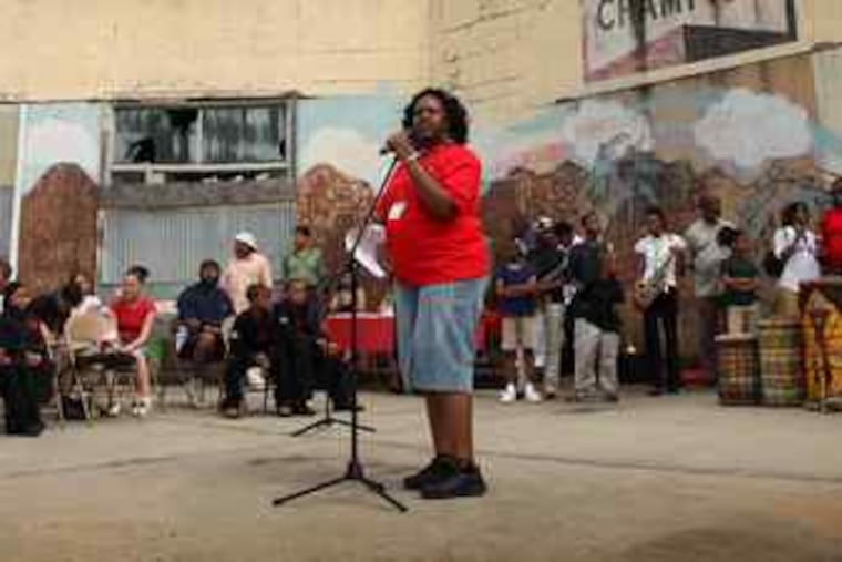 Ronsha Dickerson speaks at a rally at the Unity Community Center, aimed at releasing the property from a tax lien.