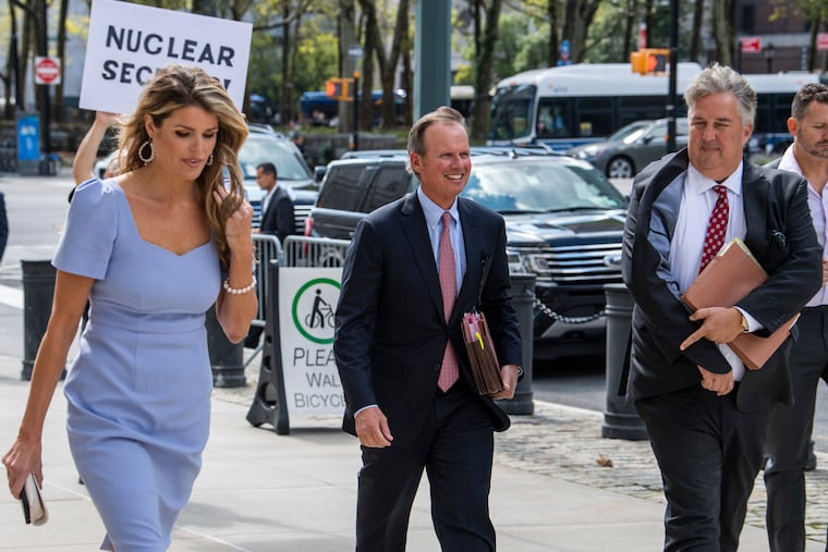 Former President Donald Trump's attorneys Linsey Halligan, James Trusty, and Chris Kise arrive at Brooklyn Federal Court on Tuesday.