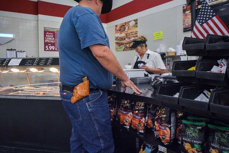 Lee Bird carries his .38-caliber pistol on his hip everywhere he goes. That includes his local grocery store in Wickenburg, Ariz. Photo by Jacob Byk/News21.