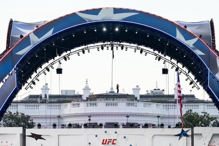 FILE - Security at the White House looks through a pair of binoculars during the UFC Fan Fest on the White House Ellipse ahead of Sunday's fight on the South Lawn, June 13, 2026, in Washington.