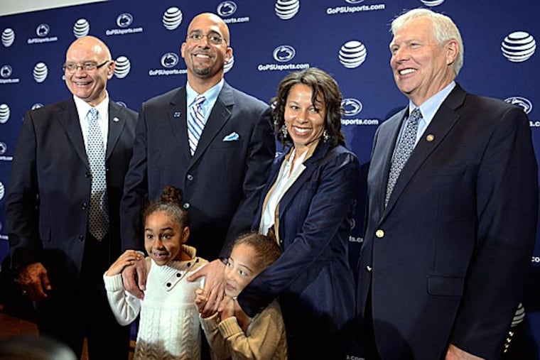 Penn State's new football coach, James Franklin, poses for photos after he was introduced with his wife, Fumi Franklin, and Penn State President Rodney Erickson. (John Beale/AP)