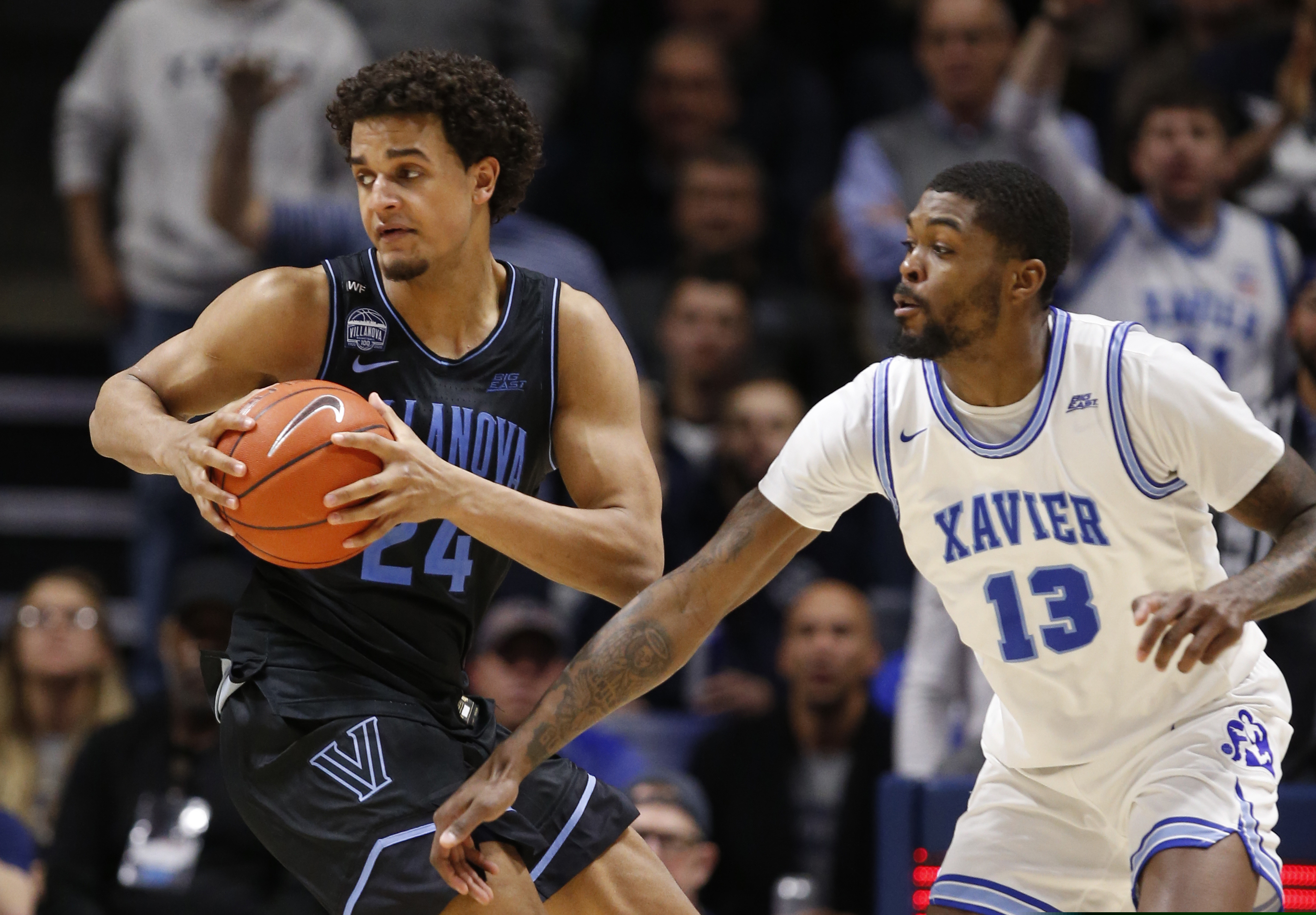 Villanova forward Jeremiah Robinson-Earl (24) is pressured by Xavier forward Naji Marshall during Saturday's win.