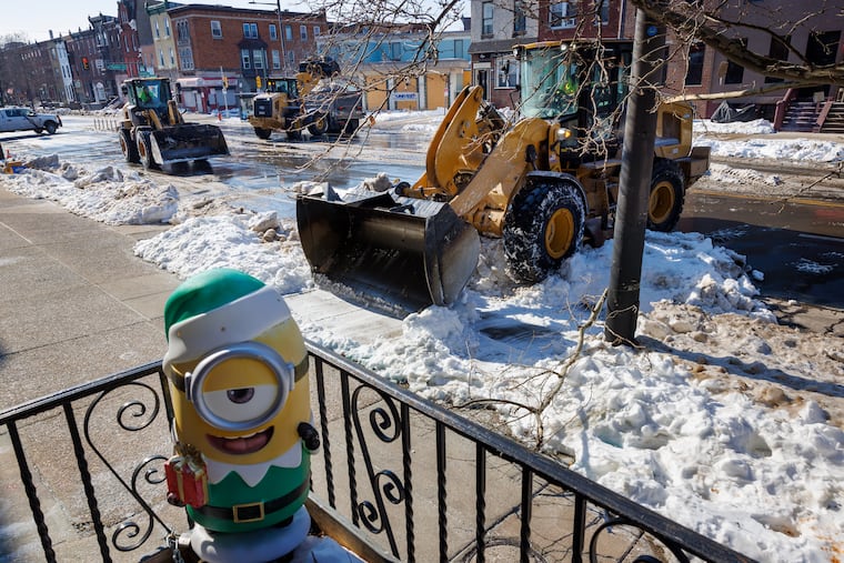 Heavy equipment clears snow along S. Broad Street near Tasker Street Tuesday, Feb. 3, 2026, in south Philadelphia.