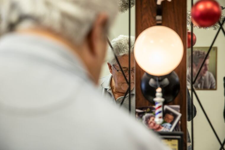 Tony Martone, owner of the Colonial Deluxe, finishes working on a customer's hair. The shop, owned by Martone for 48 years, is moving from the old Rohm and Haas building.