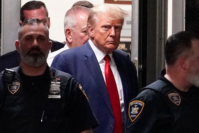 Former President Donald Trump is escorted to a courtroom on April 4, 2023, in New York.