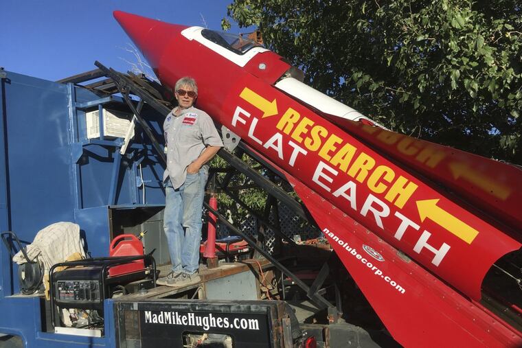 In this Wednesday, Nov. 15, 2017, photograph, daredevil/limousine driver Mad Mike Hughes is shown with with his steam=powered rocket constructed out of salvage parts on a five-acre property that he leases in Apple Valley, Cal.
