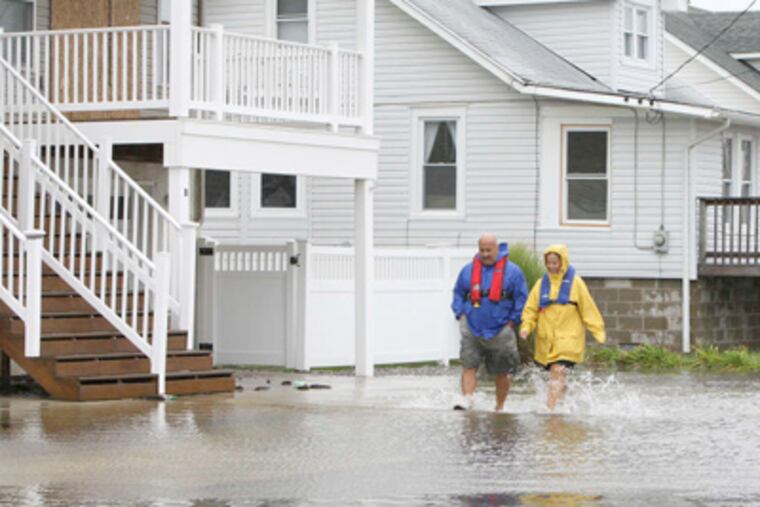 Gus and Donna Tilsner splashed through West Wildwood last August, after Hurricane Irene made landfall. (Steven M. Falk / Staff Photographer)