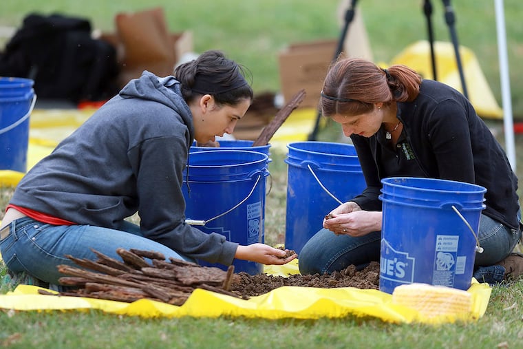 Kimberlee Sue Moran, (right) director of the Center for Forensic Science Research and Education, and Tovah Ross-Mitchell, an archaeologist from the Mutter Museum, sift through dirt from the excavation of Thomas Curry's grave at Old Cathedral Cemetery Tuesday October 7, 2014.
