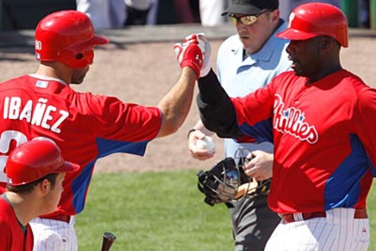 Raul Ibanez congratulates Ryan Howard on his fourth-inning home run. (Gene J. Puskar/AP Photo)