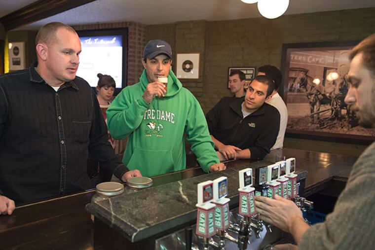 At the conclusion of a tour of Boulevard Brewery in Kansas City, Missouri, Curtis Rice, from left, and Patrick Tedesco sample beers poured by Dane Mehringer, from Boulevard's beer selections, October 23, 2013. (David Eulitt/Kansas City Star/MCT)