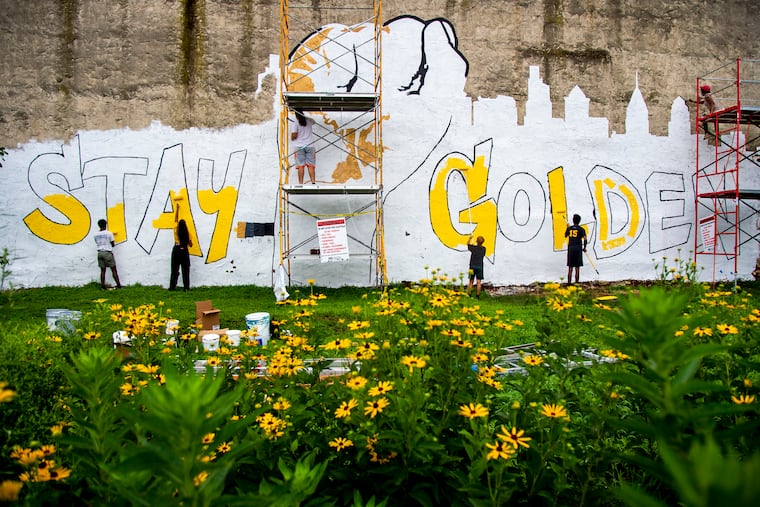Artists work on the "Stay Golden" mural in Strawberry Mansion July 25, 2020.