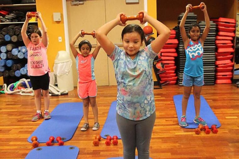 Ashley Jackson, 10, front, works out during Ricky Dickerson's fitness class, July 14, 2014 at Memorial West Hospital in Pembroke Pines, Fla., a boot camp for kids to help them stay active and healthy. (Patrick Farrell/Miami Herald/MCT)