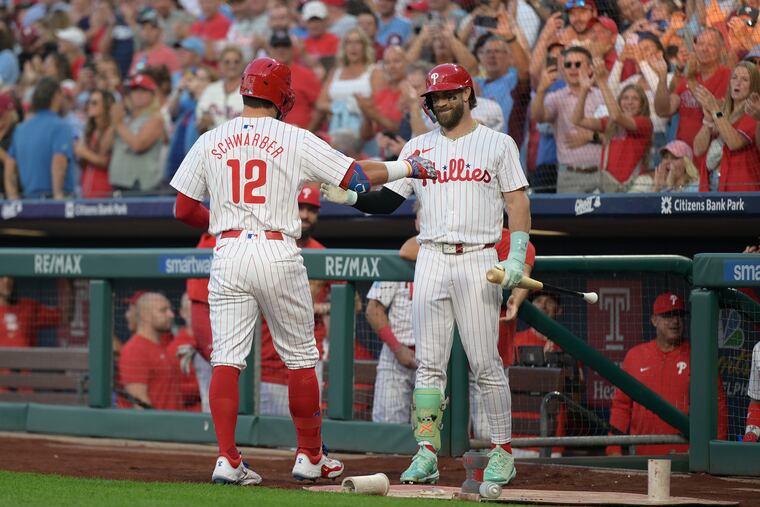 Kyle Schwarber is congratulated by Bryce Harper (right) after his record breaking 14th leadoff home run this season in the first inning.