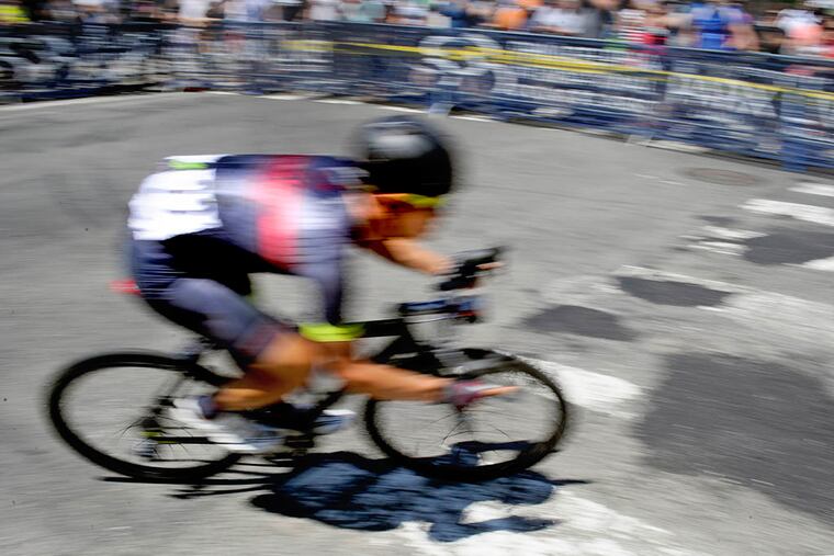 A cyclist makes the turn off Main Street in Manayunk, heading toward Levering Street and the bottom of the Manayunk Wall in the Philadelphia International Cycling Classic Sunday, June 7, 2015.