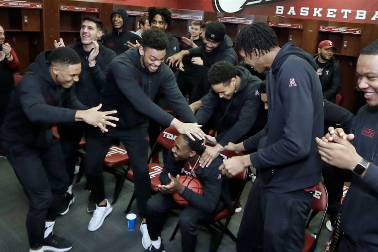 Shizz Alston (center) celebrates with his Temple teammates after they found out they earned a berth in the NCAA Tournament.