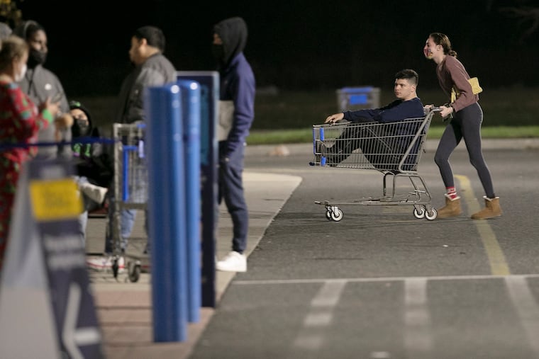 Shortly after 2 am Kimberly Stephens of Wash. Twp. pushes Andrew Rafter of Clementon in the shopping cart and into the line so they can be eady for when this Walmart on Clements Bridge Rd. in Deptford, N.J. opens at 5 am on Black Friday November 27, 2020. The coronavirus (COVID19) and the social distancing needed to combat the pandemic have changed the retail landscape.