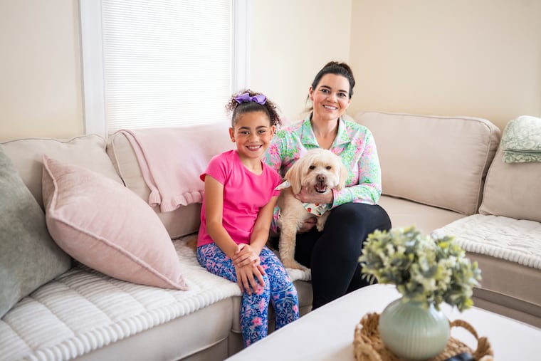 Amanda Caroccio (right) poses for a portrait with her 8-year-old daughter, Guiliana (left), and rescue dog, Simba, at their home in Haddonfield, NJ on Tuesday, June 30, 2026.