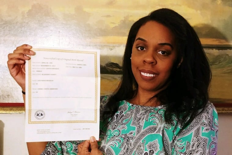 Mary Gant, who was born in Pennsylvania in 1981, stands with a summary of her original birth certificate. She's among 2,000 adoptees born in Pennsylvania who have received their birth information in the last two months.