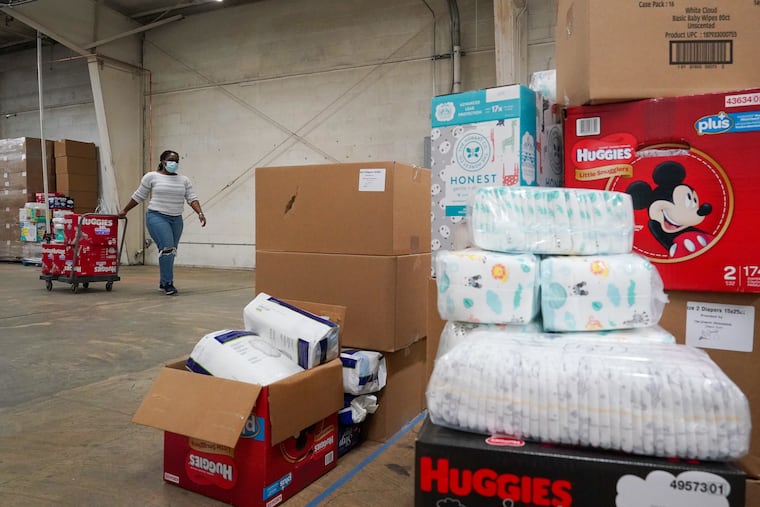 Deneen Newland puts together an order at the Greater Philadelphia Diaper Bank in Philadelphia, Pa., on November 4, 2021. The diaper bank has distributed over 7 million diapers and counting since its inception.