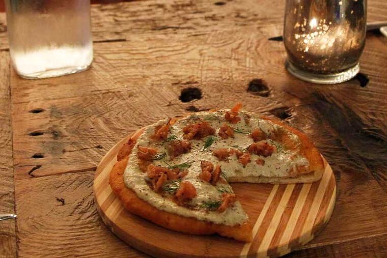 The Langos, which looks like a pizza, with one slice removed taken at V Street. ( RON CORTES / staff Photographer }