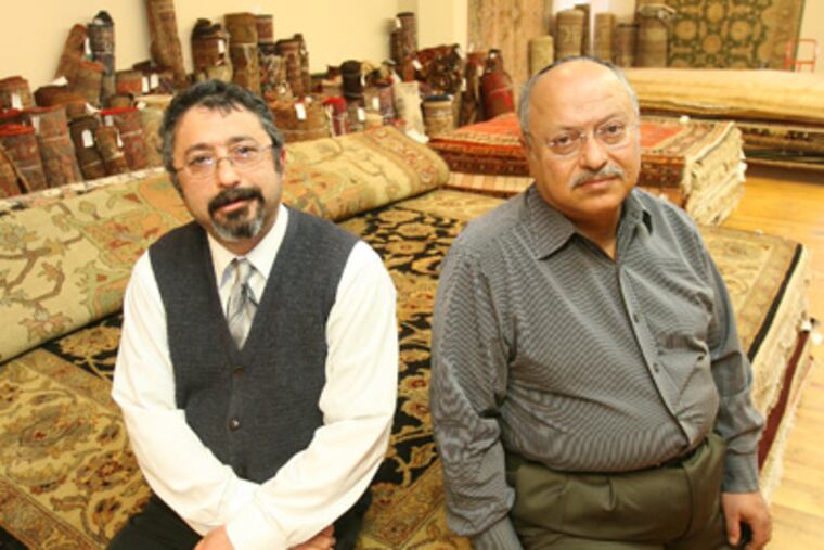 For their going-out-of-business sale, Main Line rug dealers Benjamin (left) and Reuben Tehrani and their liquidator hired a rival. (Charles Fox / Staff Photographer)