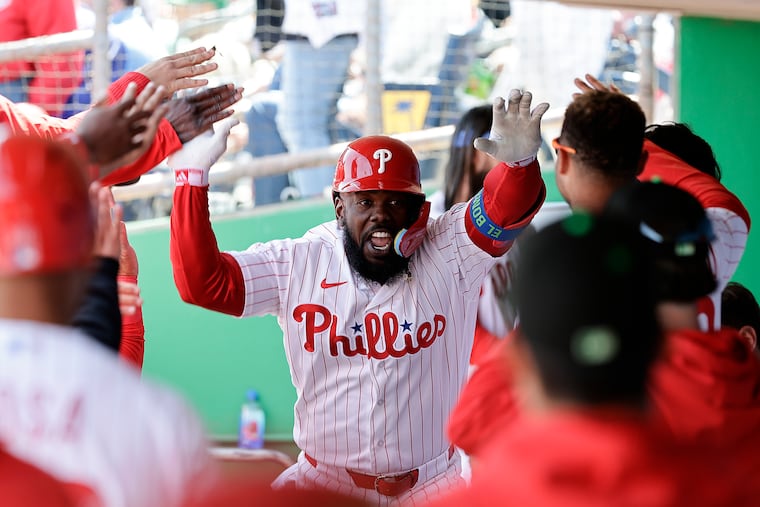 Adolis García celebrates his fourth-inning home run in the Phillies dugout on Tuesday.