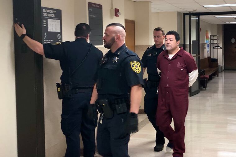 Chong Ling Dan is escorted out of a courtroom in the Montgomery County Courthouse after being sentenced to life in prison for the death of Ebony Pack.
