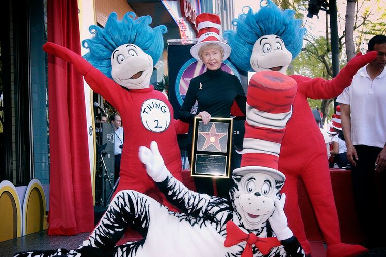 FILE - In this March 11, 2004, file photo, Audrey Geisel, widow of famed children's book author Theodor Seuss Geisel, better known as Dr. Seuss, poses with The Cat in the Hat, foreground, and Thing 1 and Thing 2, who are characters from his books, at the dedication of Dr. Seuss' posthumous star on the Hollywood Walk of Fame in Los Angeles. Geisel died at her La Jolla, Calif., home on Wednesday, Dec. 19, 2018, at age 97.