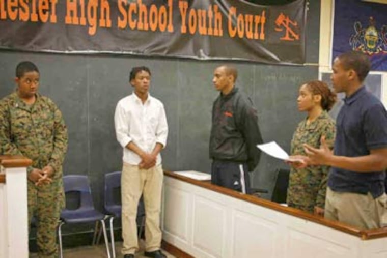 At Youth Court, advocate Brian Foster (left) and respondent Saleeh Raheem listen to jurors (from right) Kareem Greenwood, Tiara DeVore, and Nasir Young. (Michael S. Wirtz / Staff photographer)