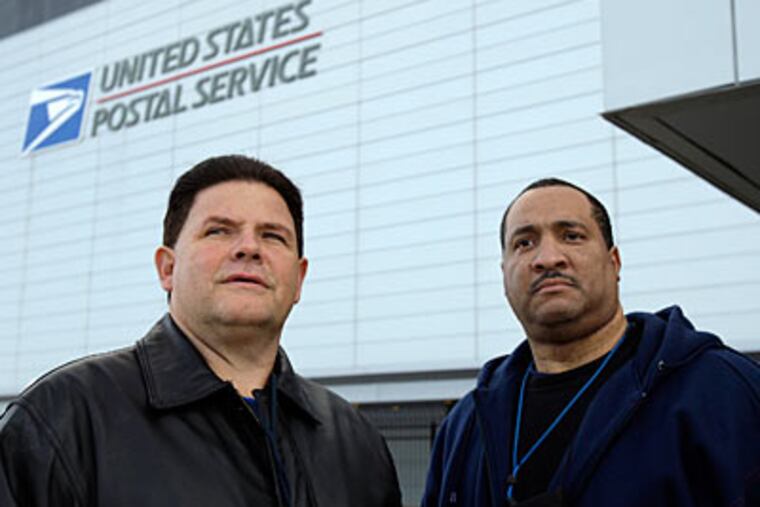Postal workers Nick Casselli, left, and Byron Murdaugh stand
outside the United States Postal Service building at 7500 Lindbergh
Blvd. ( David Maialetti / Staff Photographer )
