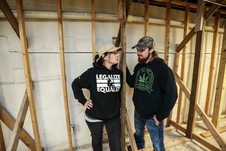 Brooke and Glen Henderson in the basement with a large crack in the foundation behind them in their home in Cochranville, PA., Wednesday, April 20, 2022. Hurricane Ida dumped 10 inches of rain in this part of Chester County, leading the Henderson's septic tank to overflow and ruin Brooke's just-harvested hemp crop that was curing in the basement and the Henderson's personal belongings as well as damaging the house foundation.