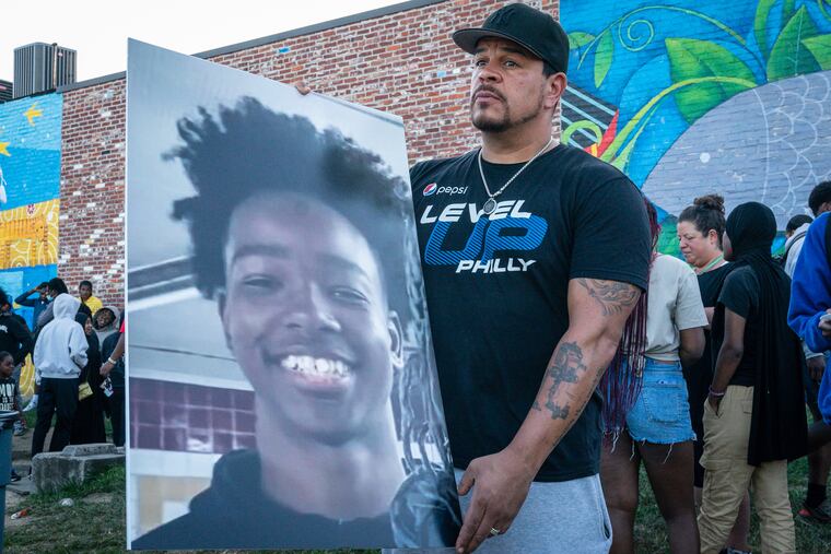 Aaron Campbell, Founder and Executive Director of Level Up, holds a photograph of 12-year-old Hezekiah Bernard in August.