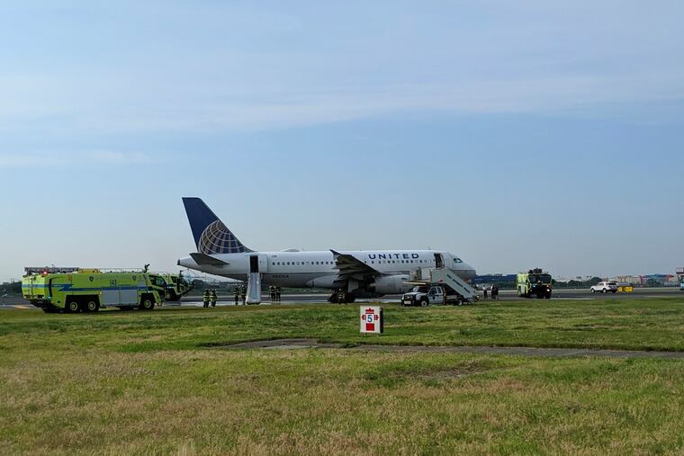 This photo provided by John Murray shows a United flight sitting on the runway after making an emergency landing, Saturday, June 29, 2019 at Newark Liberty Airport in Newark, N.J. United said Flight 2098 heading from LaGuardia Airport in New York experienced problems upon takeoff just before 8 a.m. Saturday. The Port Authority of New York and New Jersey said it was “hydraulics problems.”
