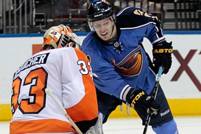 Brian Boucher anticipates a shot from Atlanta's Bryan Little during Thursday night's loss. (John Bazemore/AP)